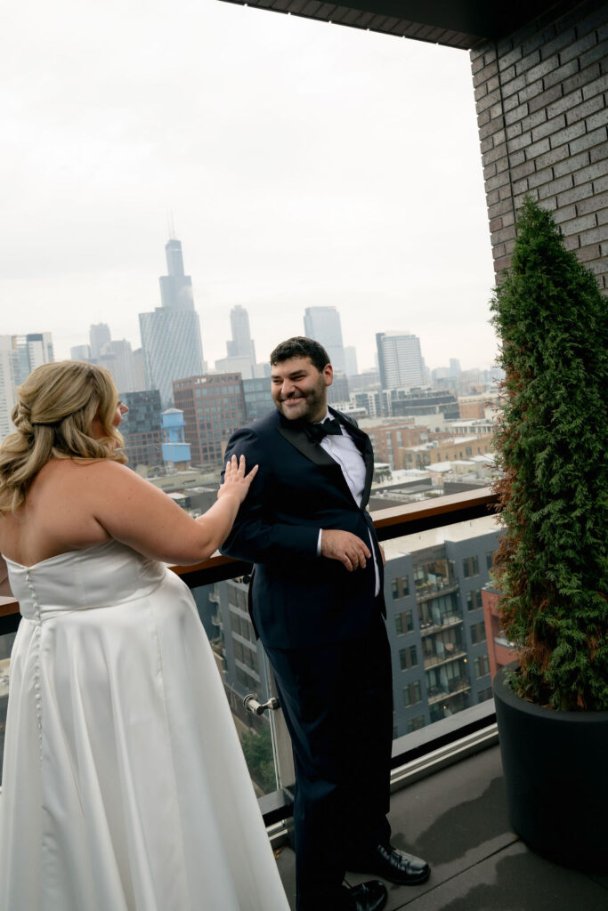 Groom turns to see his bride for the first time during their first look in West Loop, Chicago