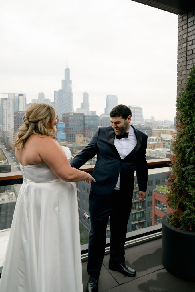 Groom turns to see his bride for the first time during their first look in West Loop, Chicago