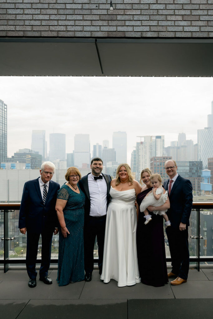 Bride and groom pose with their families at Hyatt Hotel in Chicago's West Loop