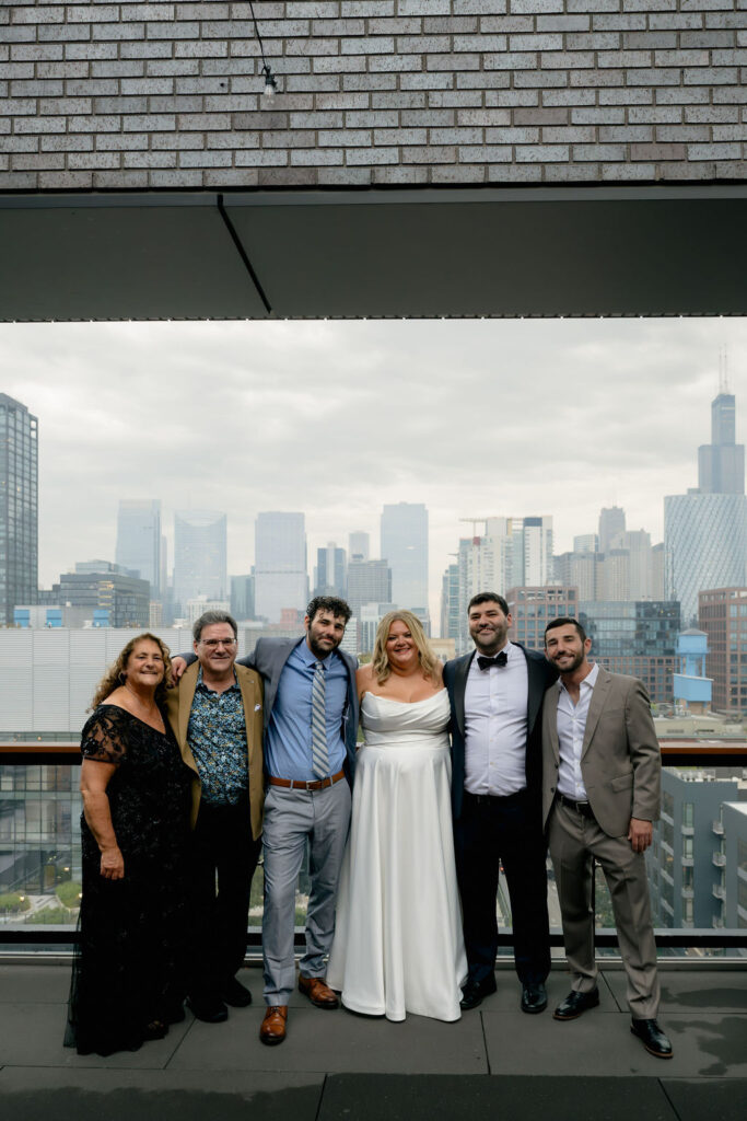 Bride and groom pose with their families at Hyatt Hotel in Chicago's West Loop