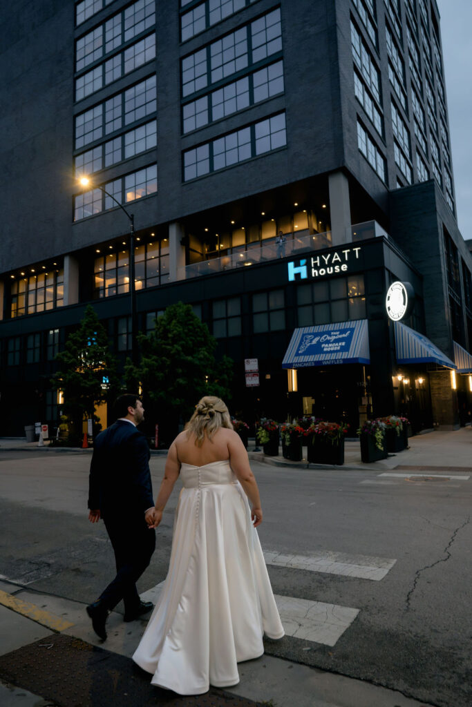 bride and groom wedding couples photos on chicago walking in street in front of hyatt hotel