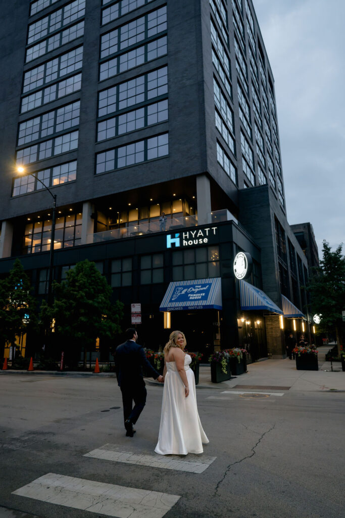 bride and groom wedding couples photos on chicago walking in street in front of hyatt hotel